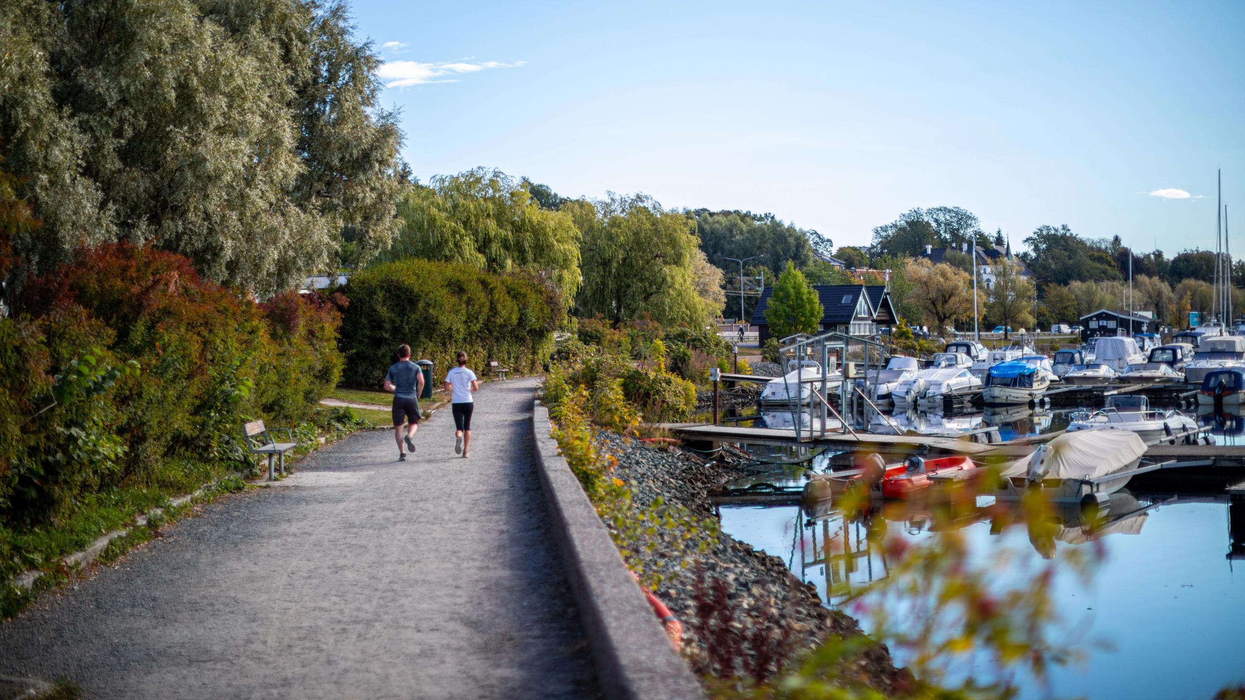 Two people running at the Frognerkilen promenade in Oslo, Eastern Norway