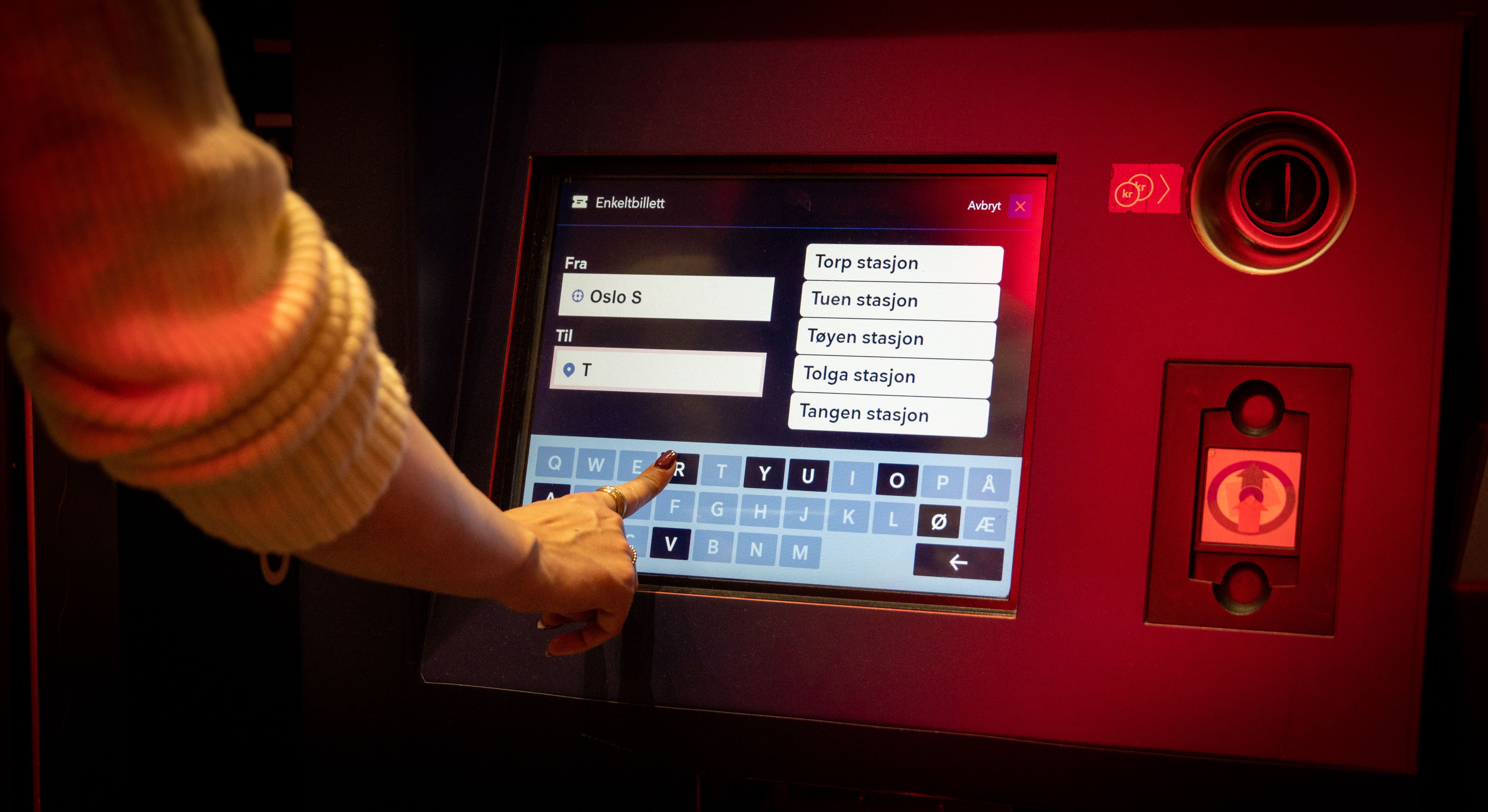 A woman buying train tickets.