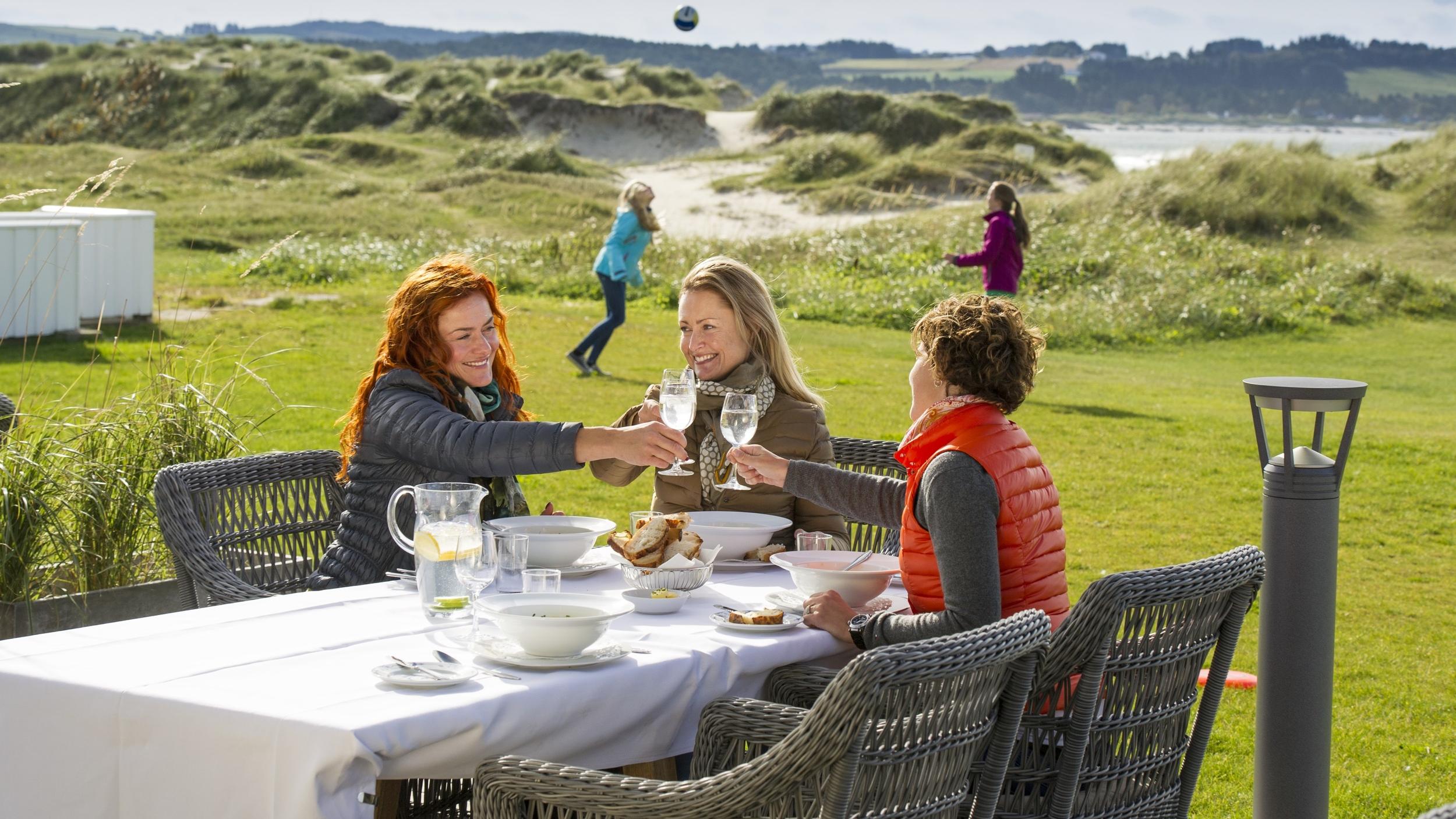 Friends enjoying lunch at Sola Strand Hotel in Jæren, Fjord Norway.