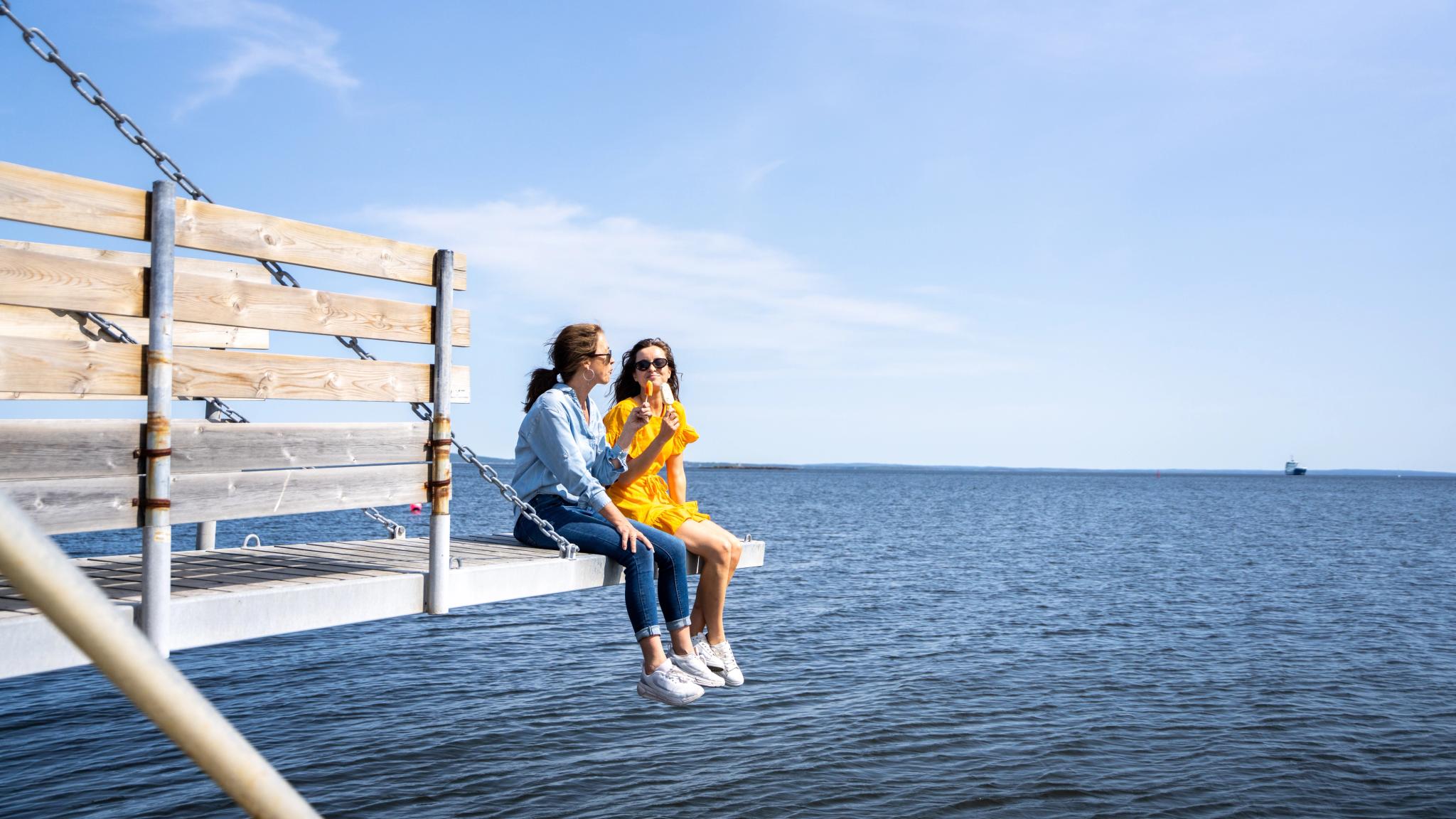 Two women eating ice cream in the port of Åsgårdstrand