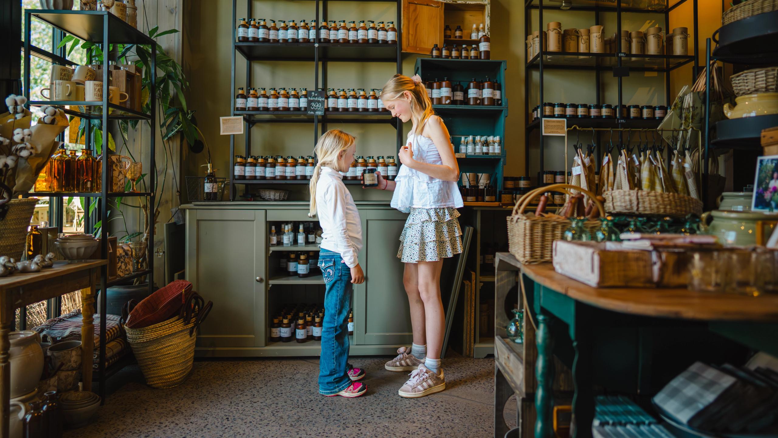 Girls in a shop with homemade products.