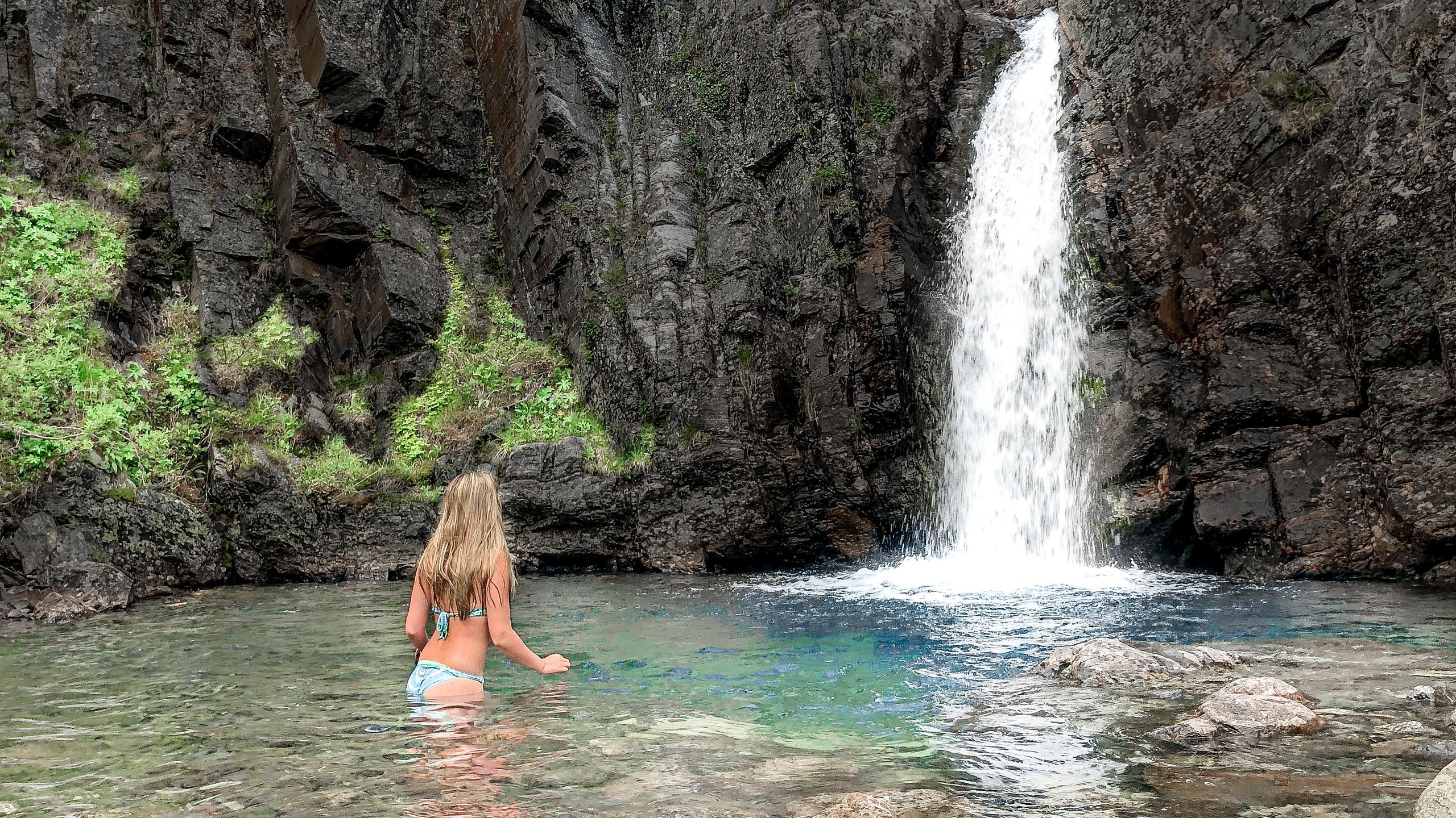 A woman bathing under a waterfall in Hemsedal, Eastern Norway