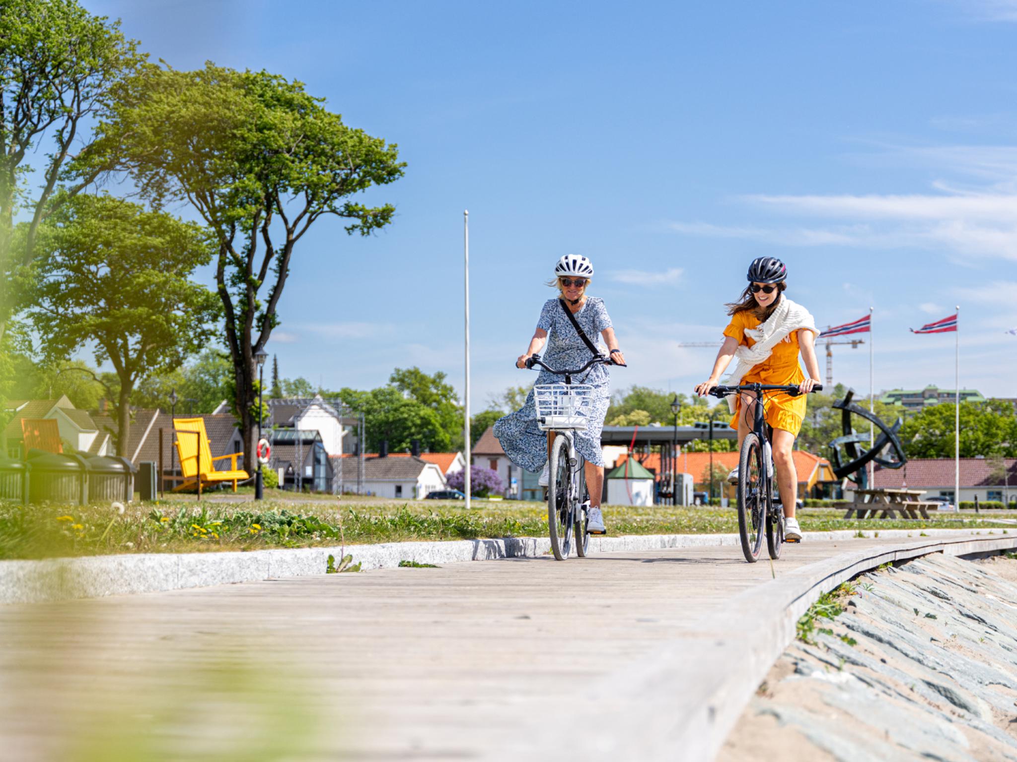 Two women biking along the beach in Moss, Østfold