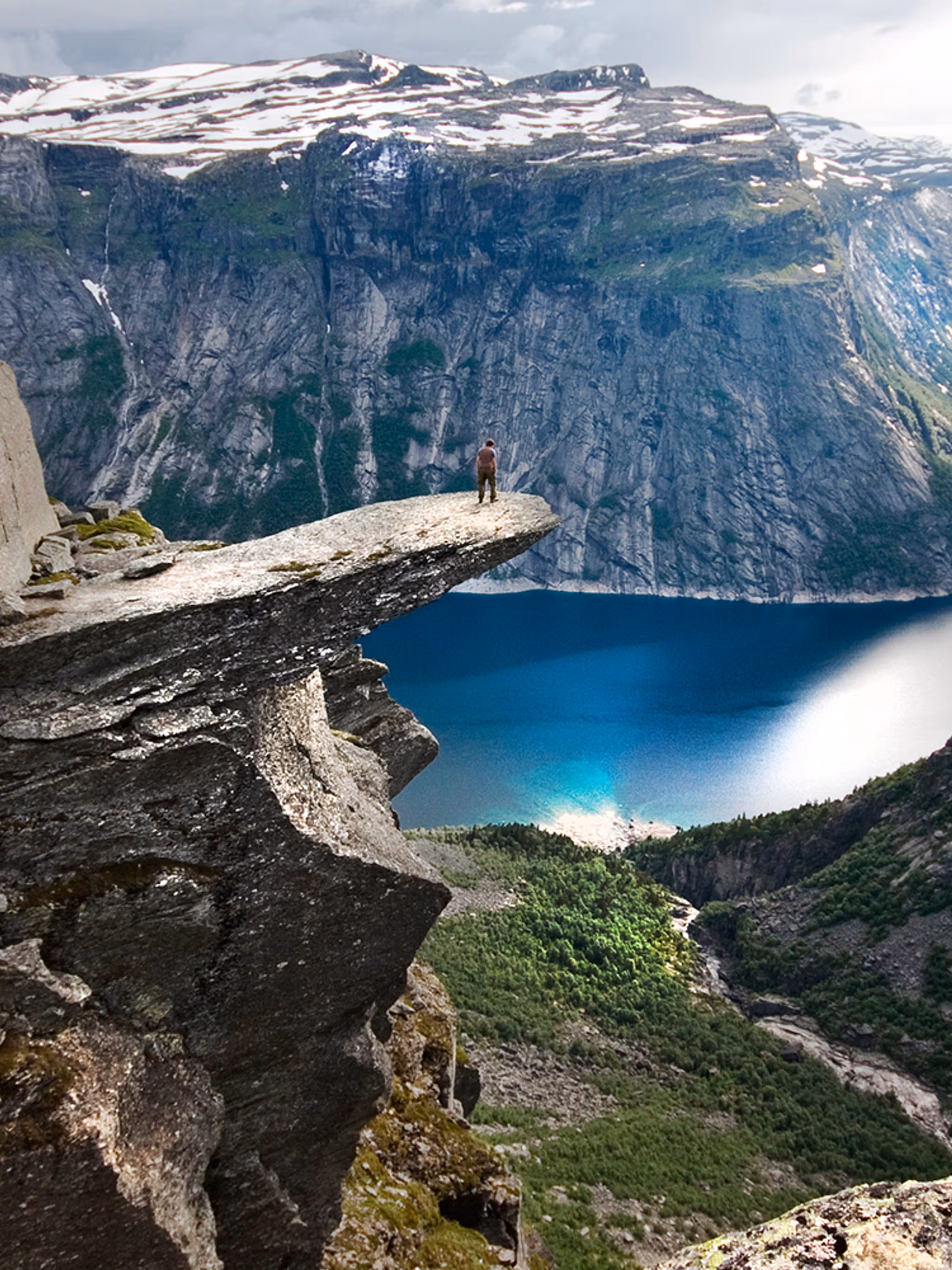 A person on the mountain plateau Trolltunga above Lake Ringedalsvatnet in the Hardangerfjord region, Fjord Norway