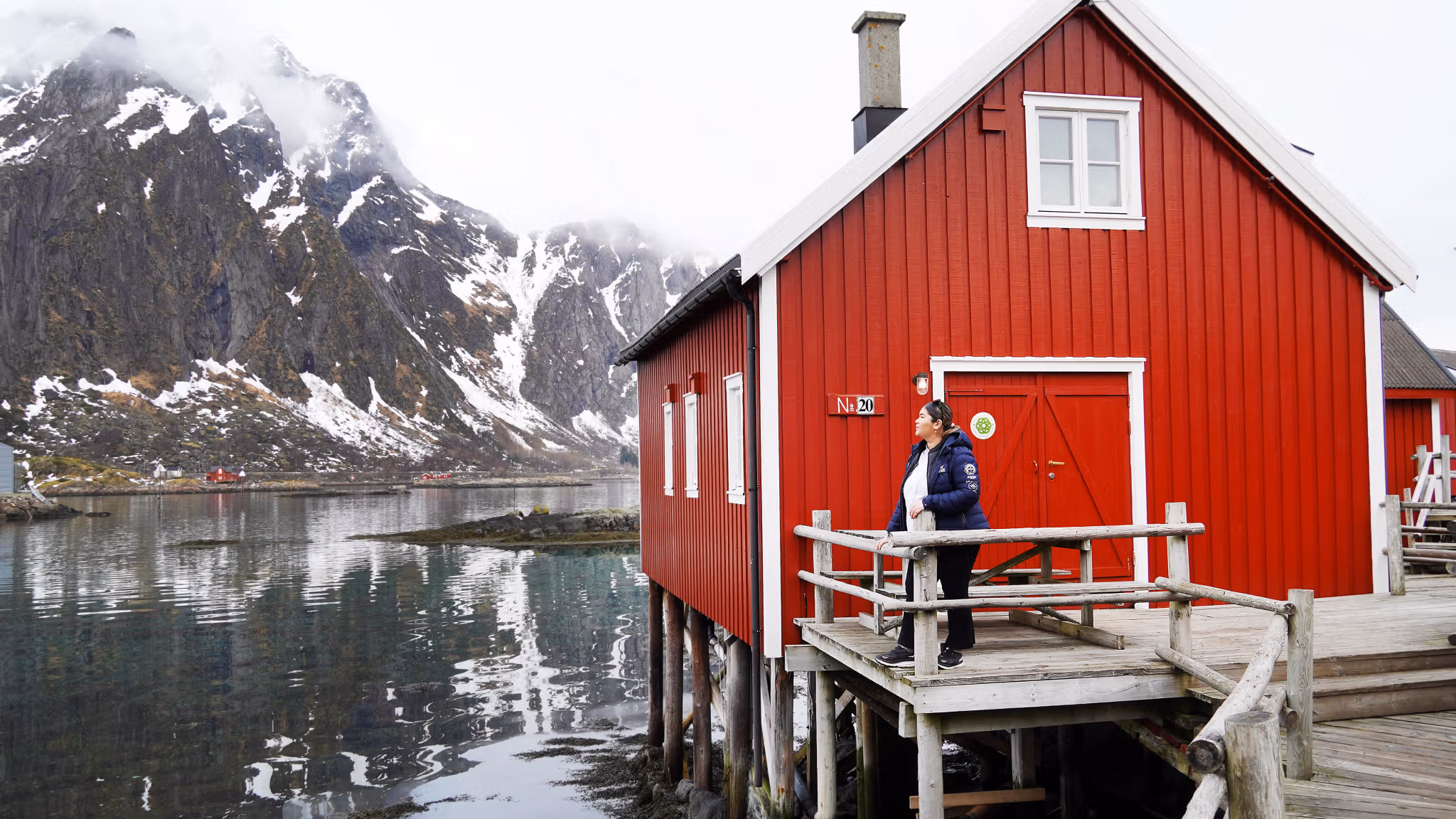 A woman in front of a fisherman´s cabin