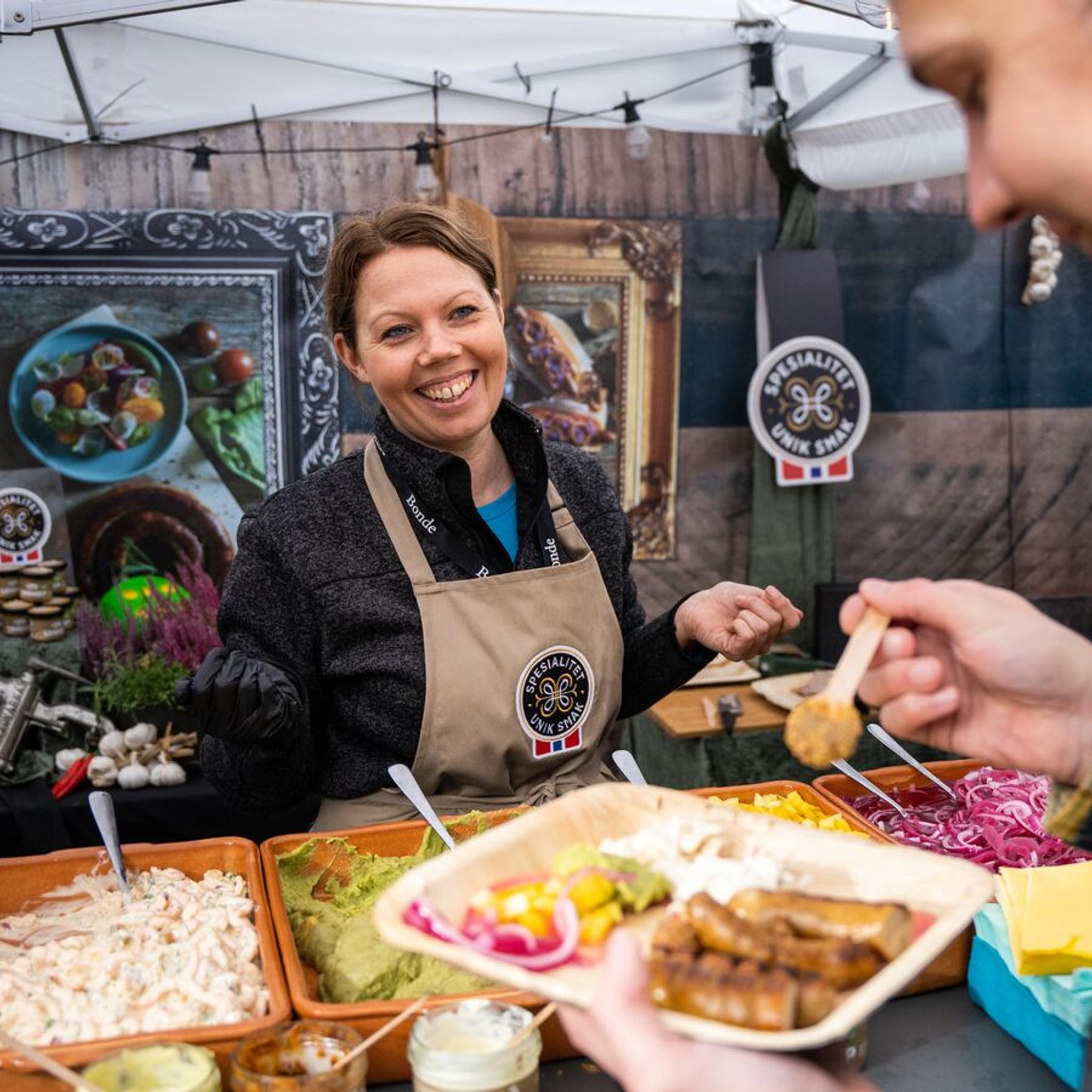 A man eating a serving of sausages at the Matstreif food festival in Oslo