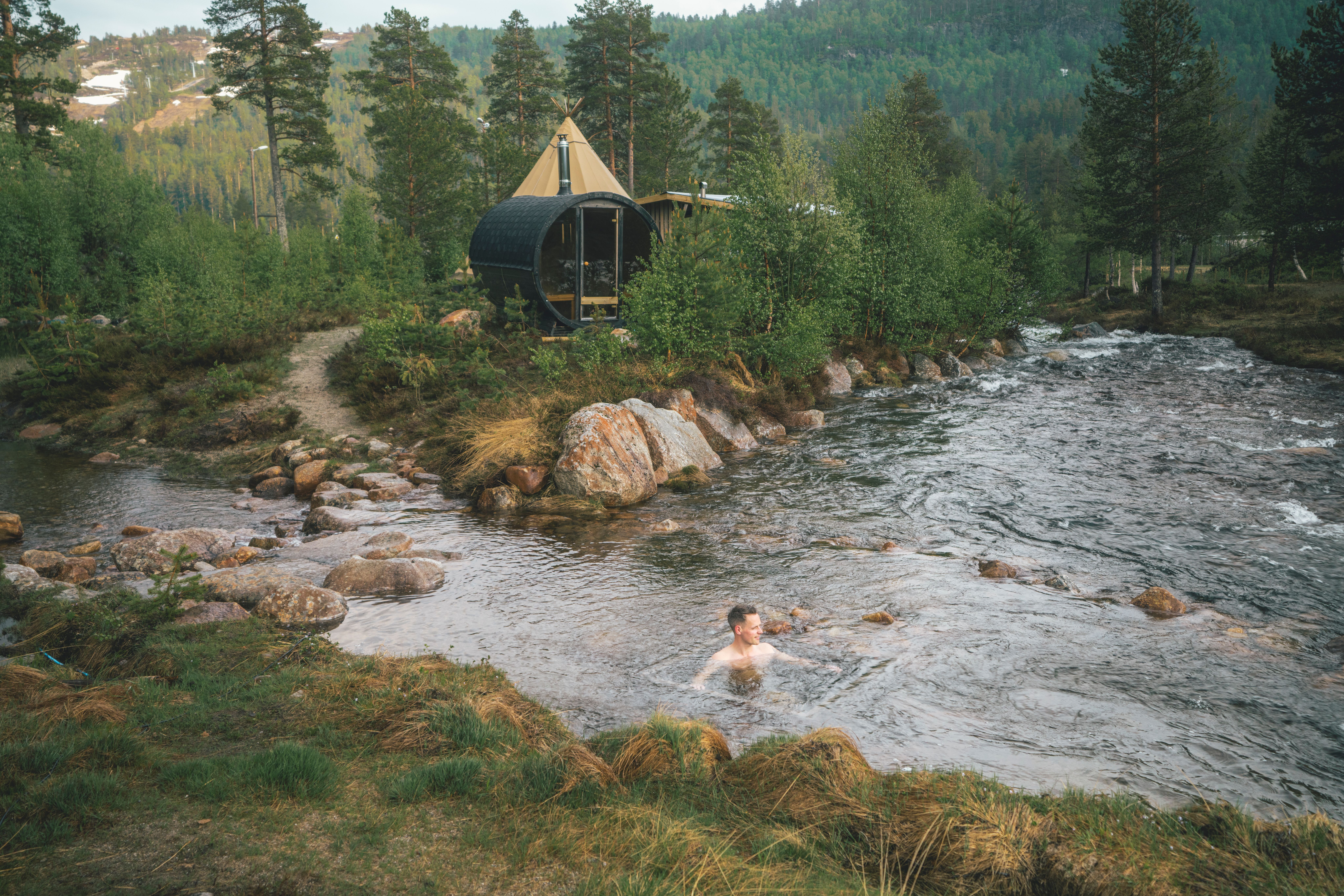 A person taking a dip in the river at Brokkestøylen in Southern Norway