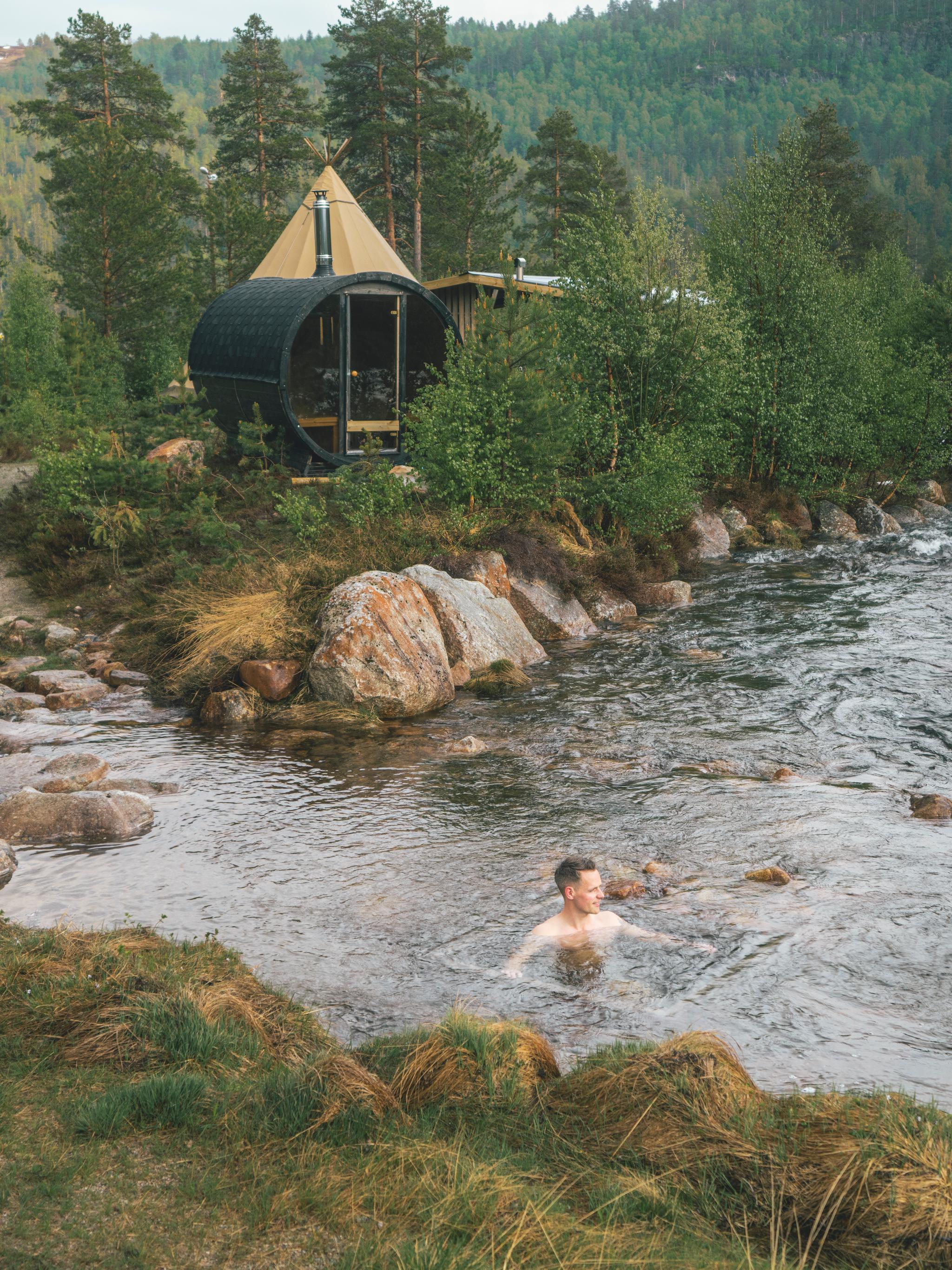 A person taking a dip in the river at Brokkestøylen in Southern Norway