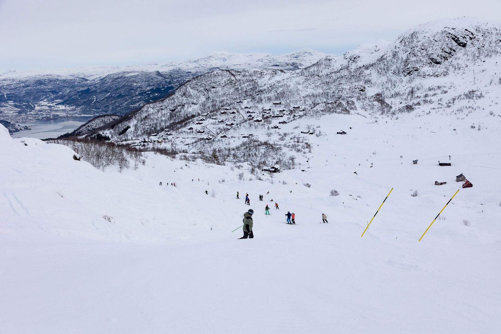People skiing down a slope.