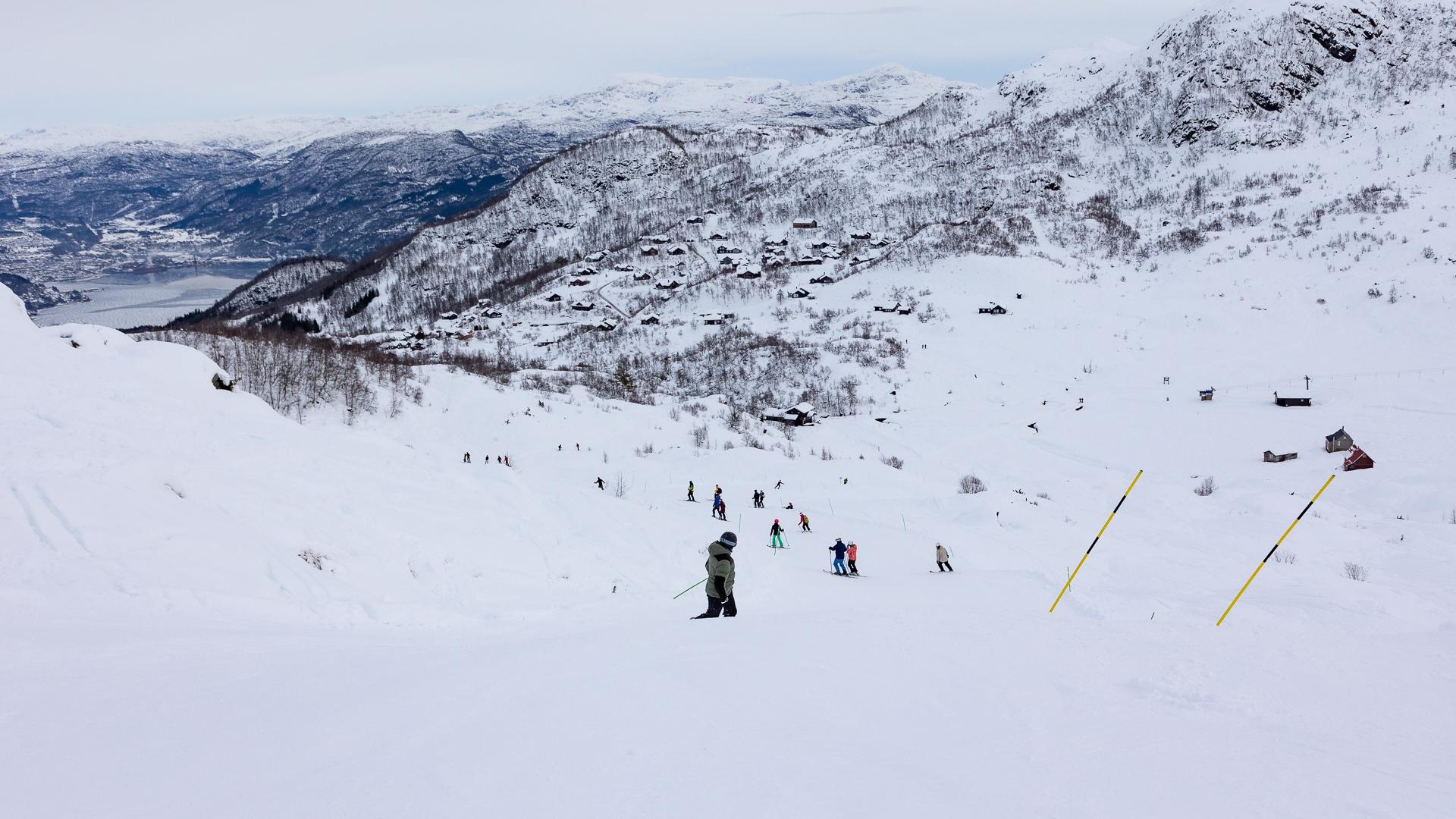 People skiing down a slope.