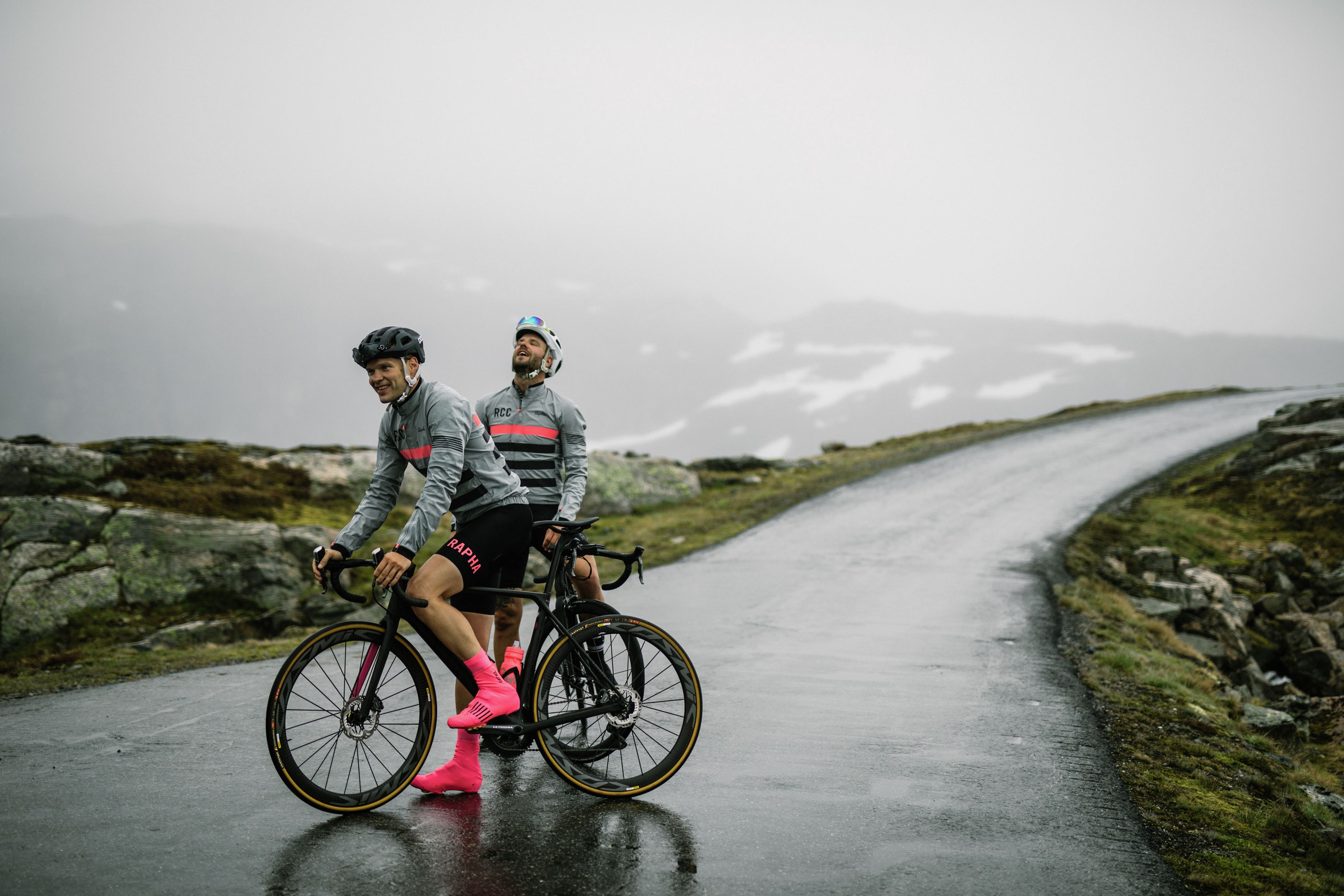 Two road cyclists on a rainy day in Fjord Norway
