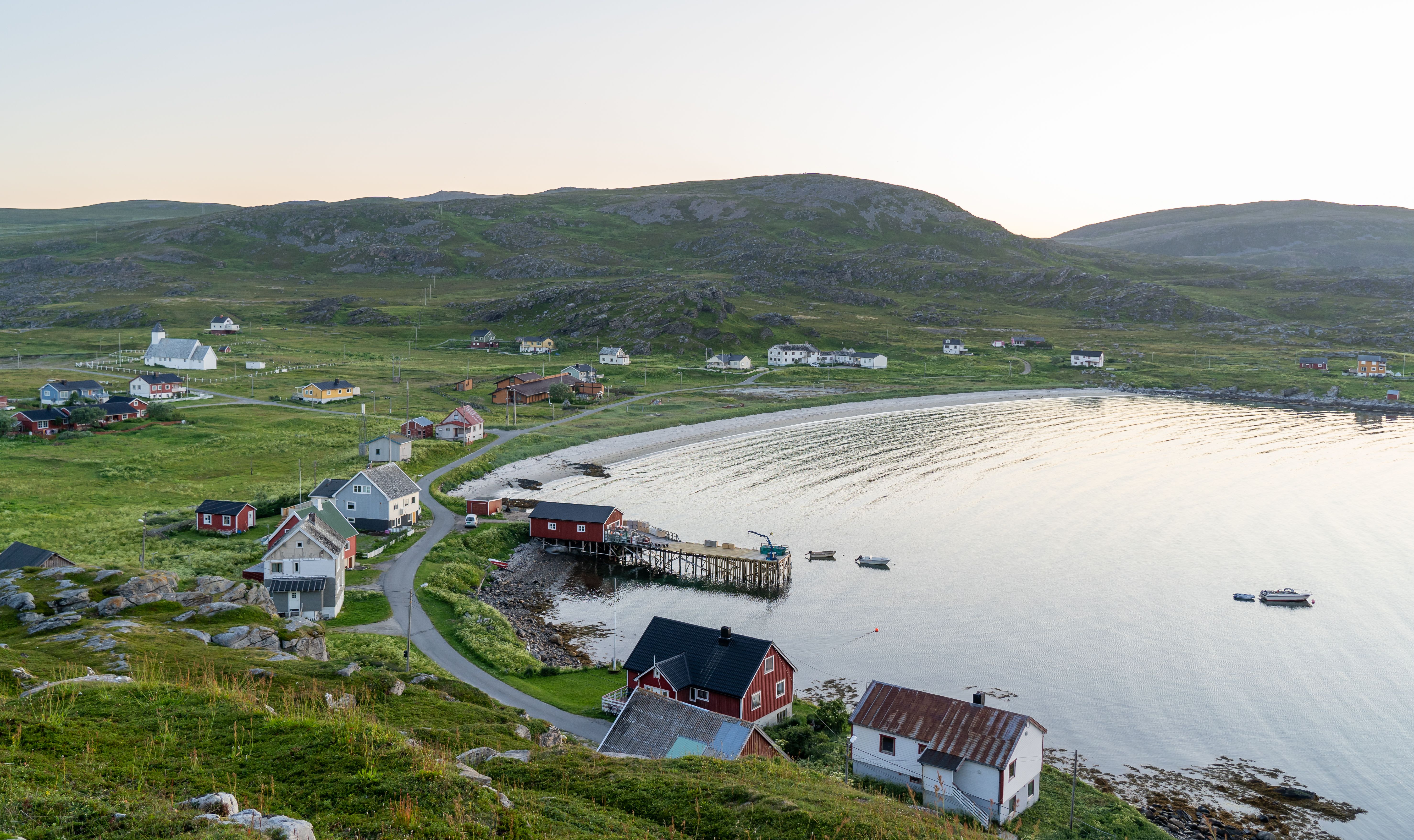 View of the landscape on Måsøya with houses and the sea 