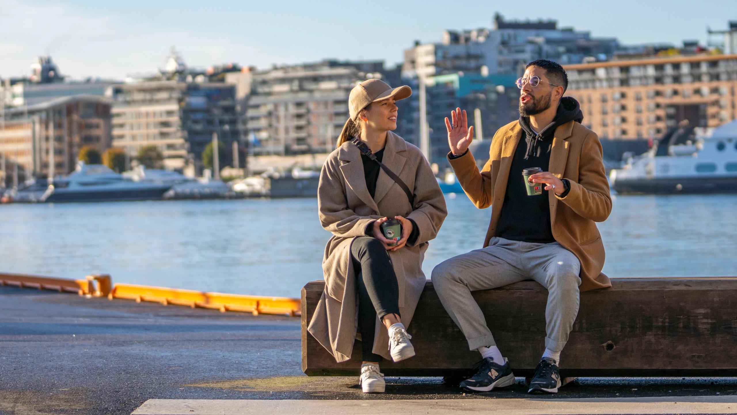 Two friends sitting at Festningskaia in Oslo, Norway