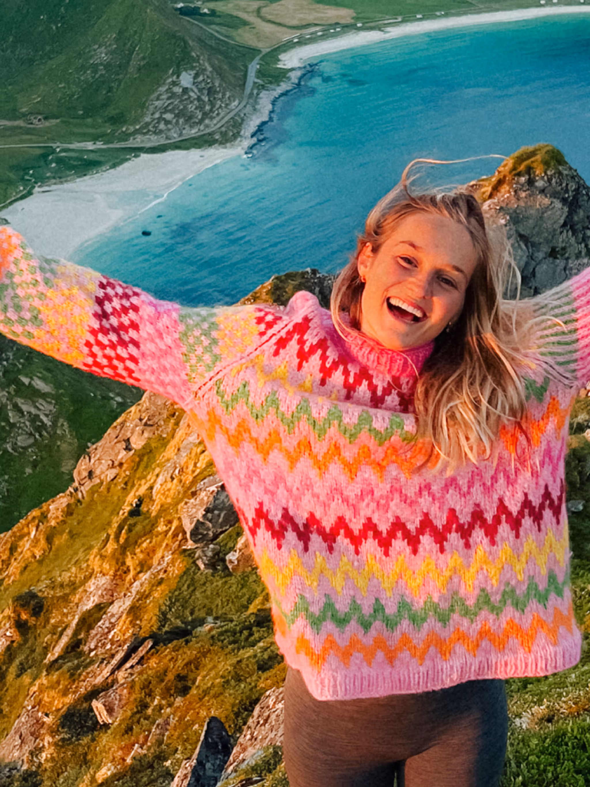 Helene Myhre hiking in a colourful knitted sweater