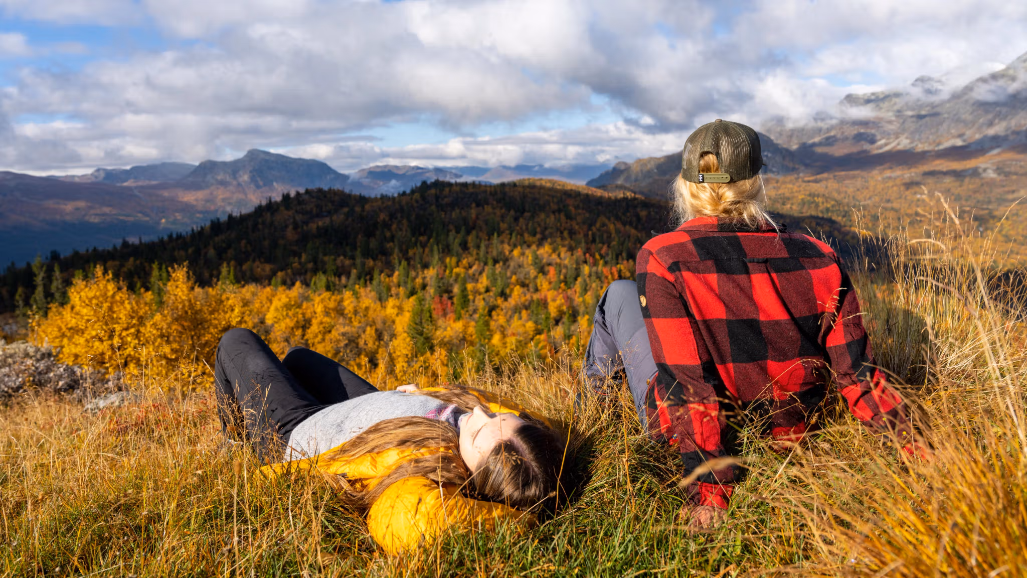 Two girls relaxing and enjoying the view of the autumn/fall forest in Hemsedal, Eastern Norway