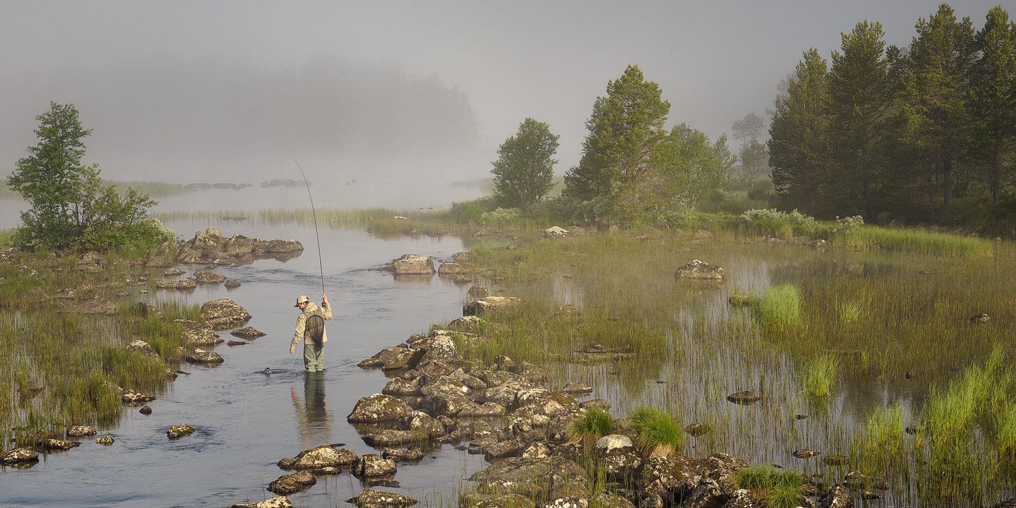 A man fly fishing in a river in Skurdalen in Eastern Norway