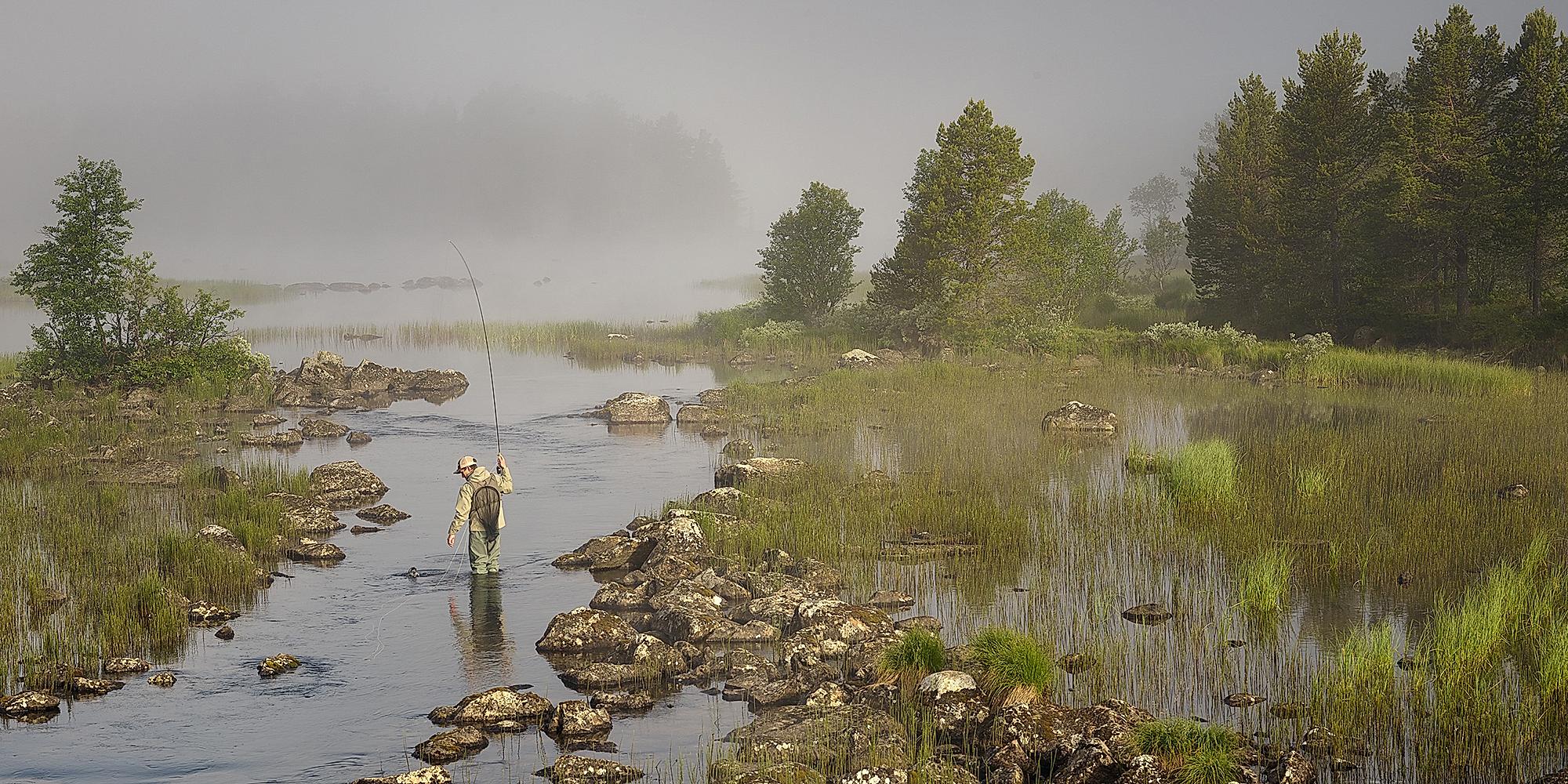 A man fly fishing in a river in Skurdalen in Eastern Norway