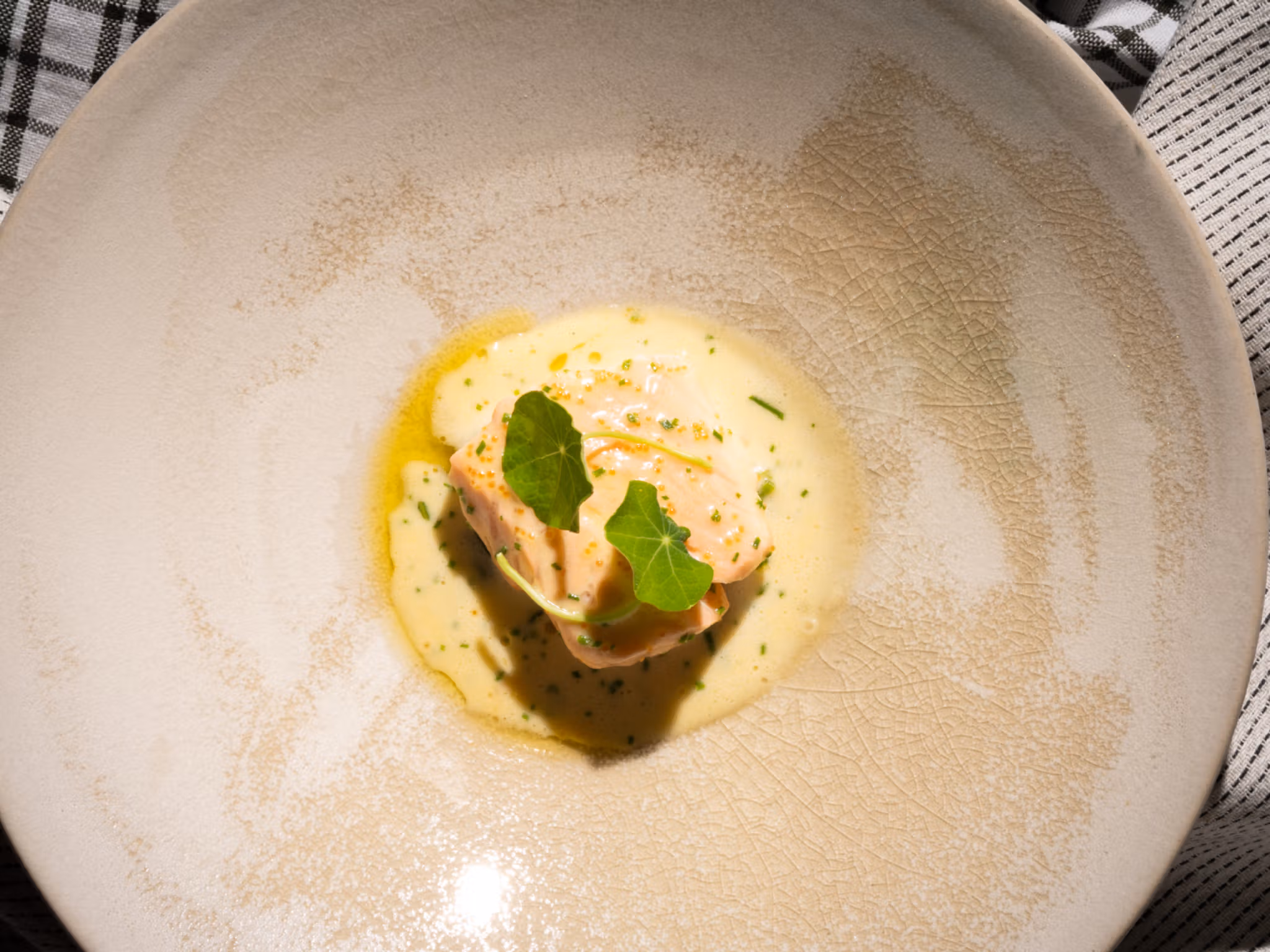 A plate with traditional baked salmon with Sandefjord butter made by star chef Tom Victor Gausdal.