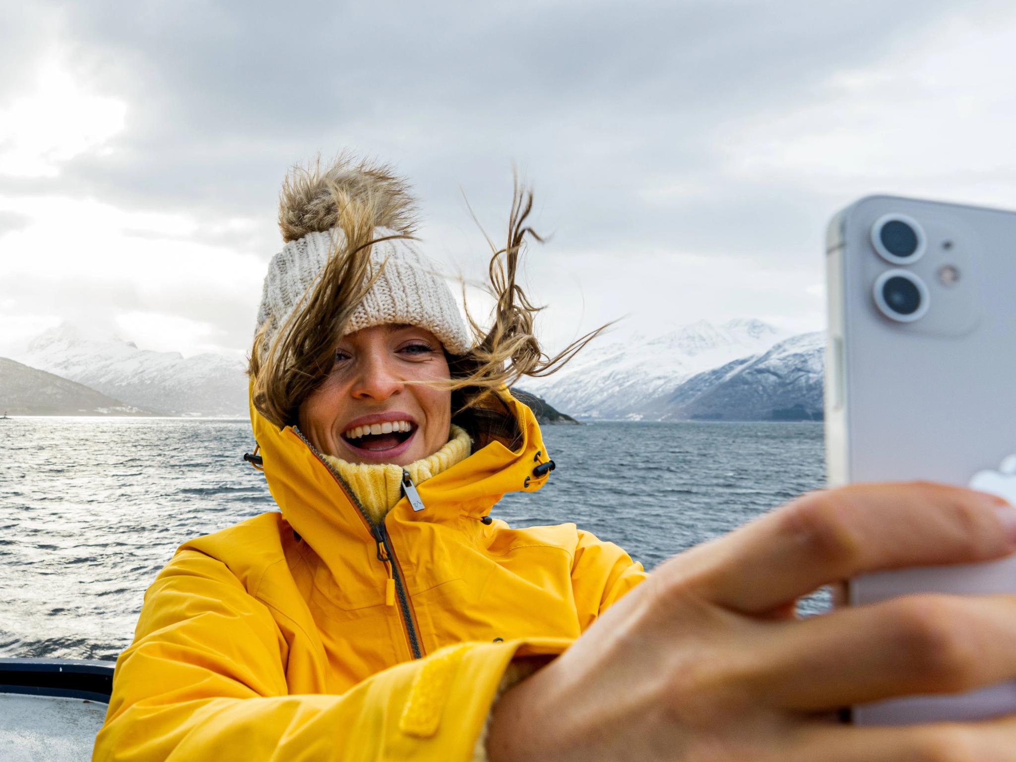 Woman taking a selfie on a winter cruise on the Geirangerfjord