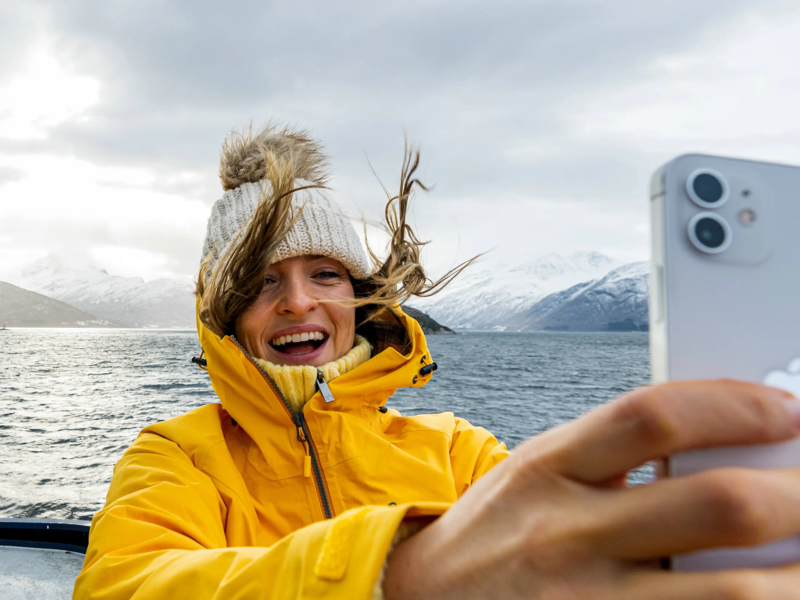 Woman taking a selfie on a winter cruise on the Geirangerfjord