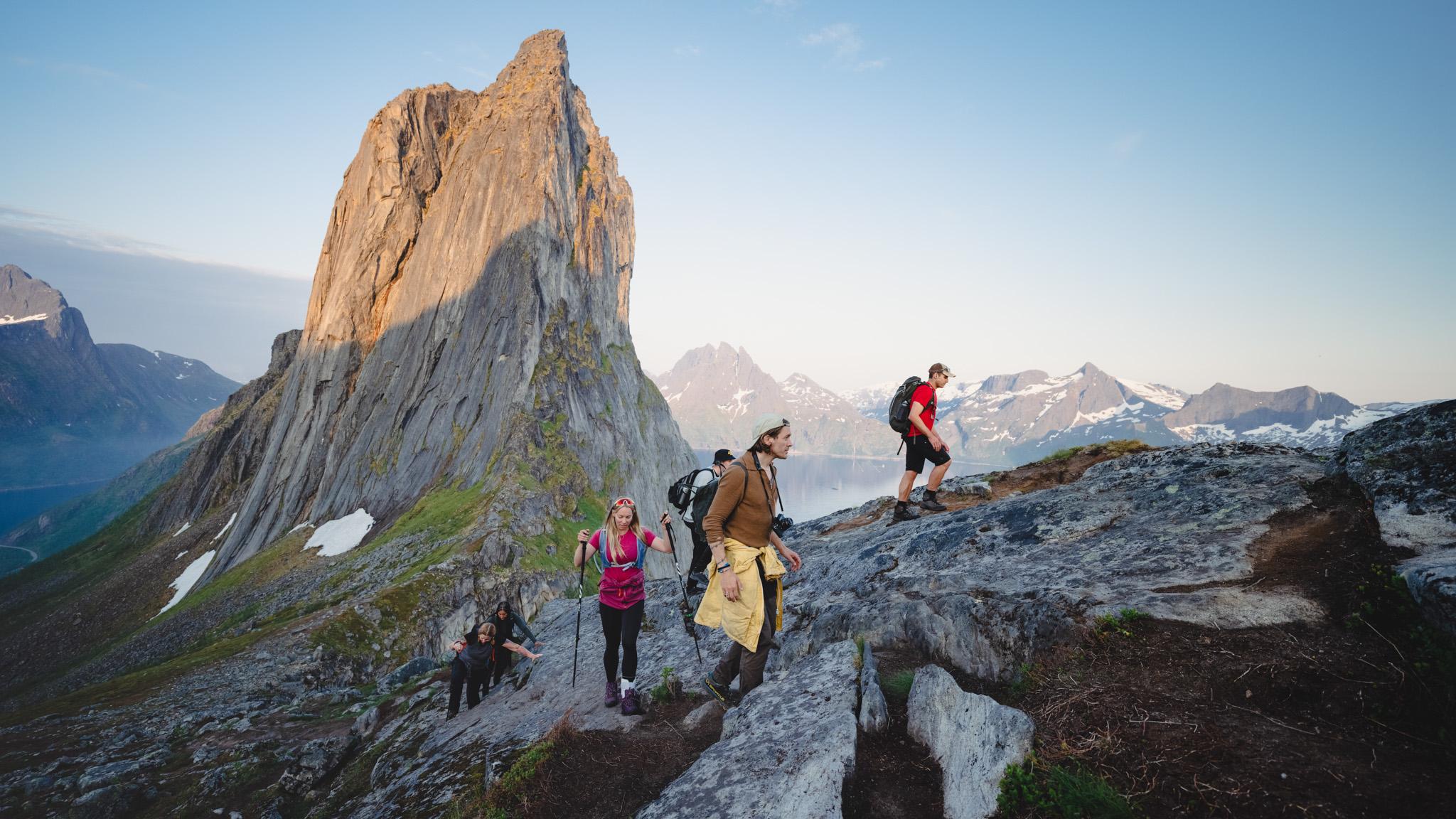 People hiking up a steep mountain with beautiful views.