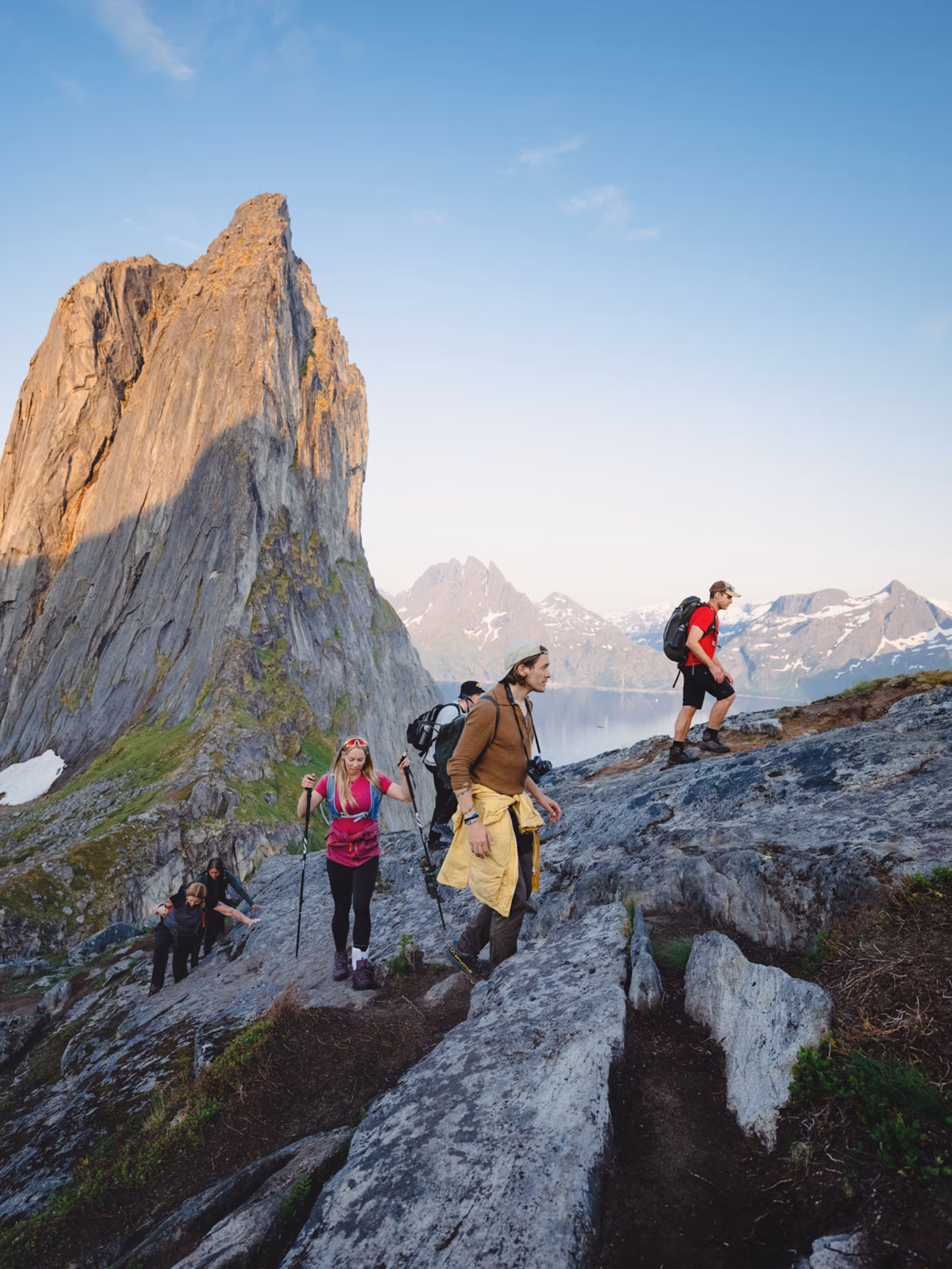 People hiking up a steep mountain with beautiful views.