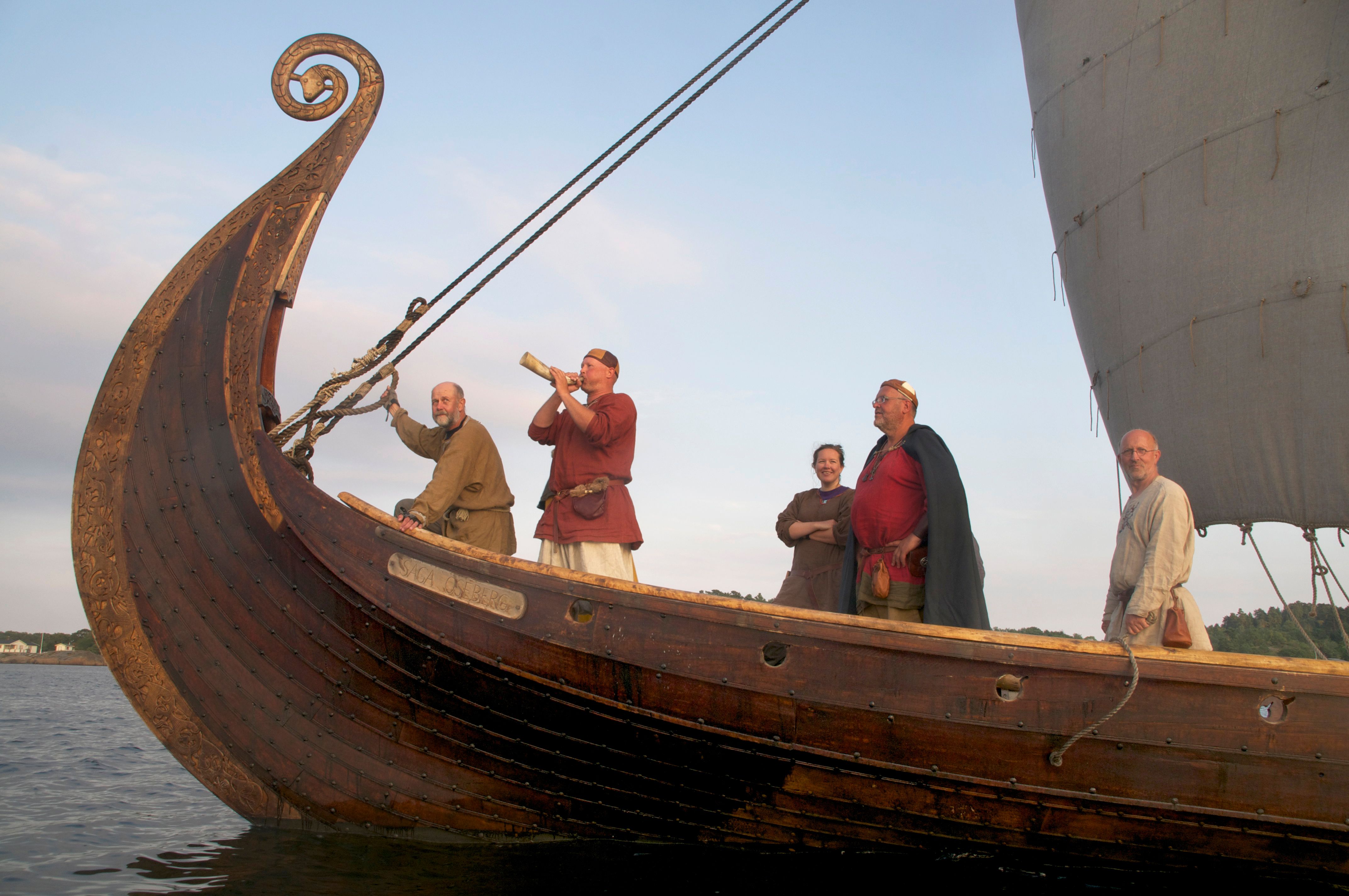 Five people in Viking outfits at the Saga Oseberg Viking ship in Tønsberg, Eastern Norway