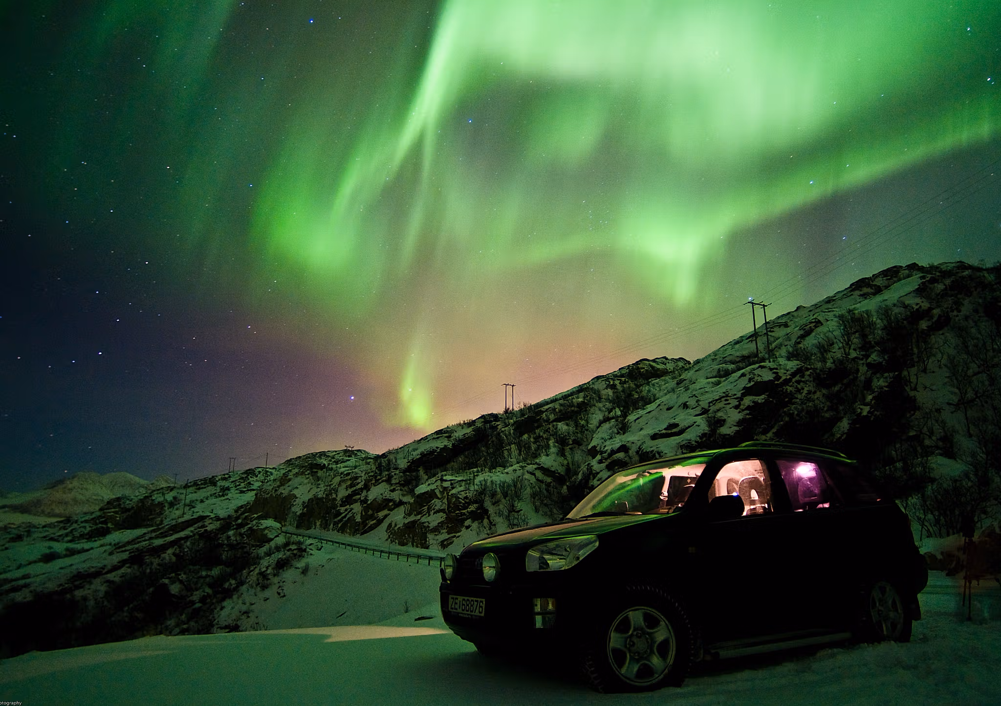 Car under the northern lights