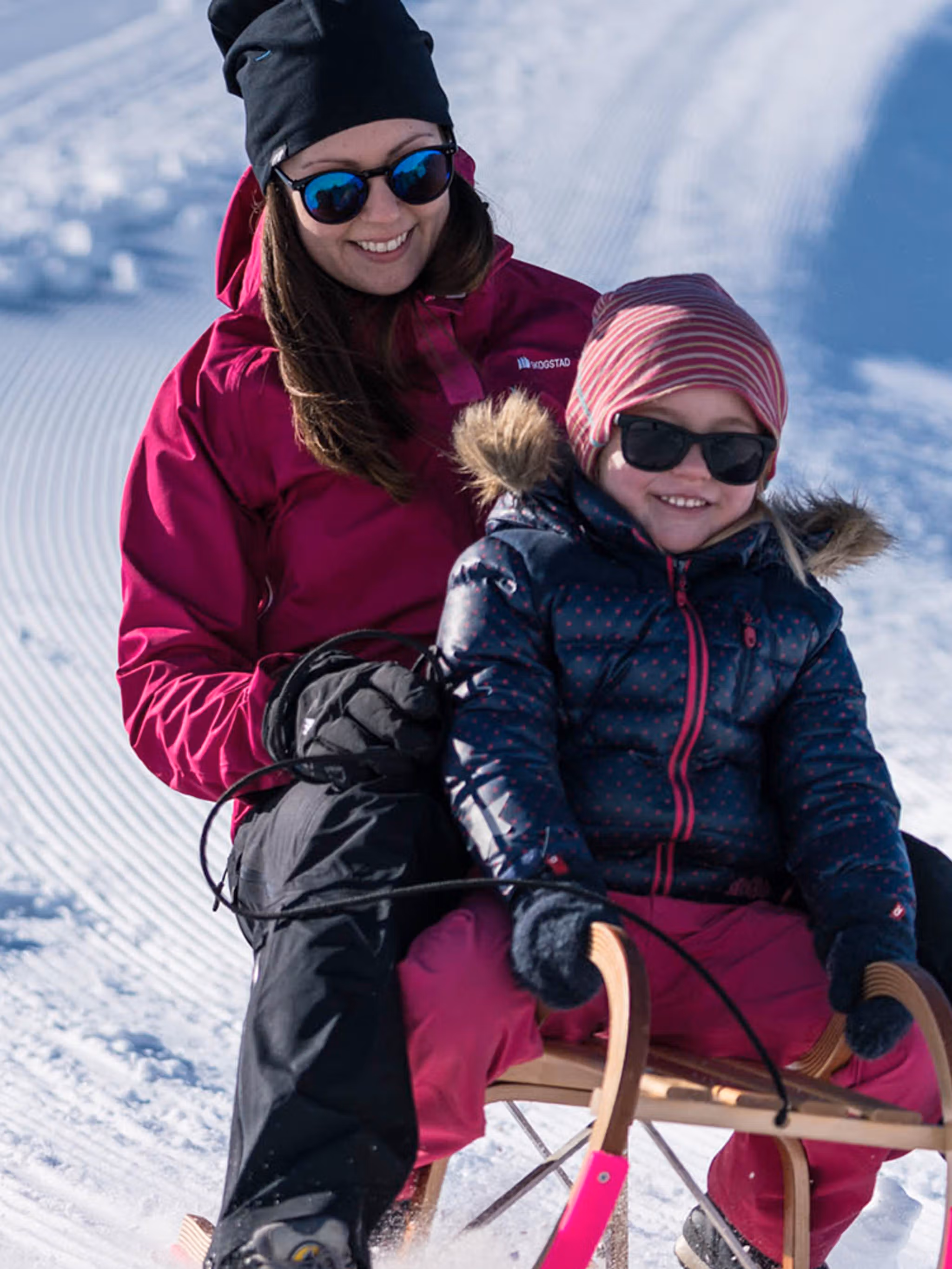 Mother and daughter tobogganing at Mount Hoven by the Loen Skylift in Loen, Fjord Norway